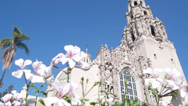 Spanish colonial revival architecture in Balboa Park, San Diego, California USA. Historic building, classic baroque or rococo romance style. Bell tower relief decor and mosaic dome or cupola. Flowers.