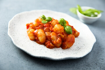 Baked potato gnocchi with tomato sauce and basil