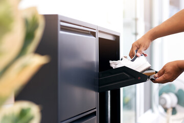 Man opening black steel shoes storage cabinet for keep her shoes