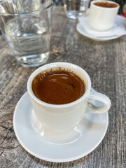 cup of coffee with water on table