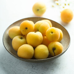 Naklejka na ściany i meble Fresh ripe apricots in a bowl