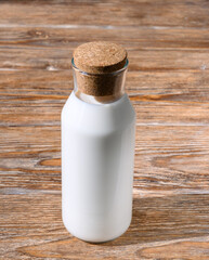 Bottle of milk on dark wooden table