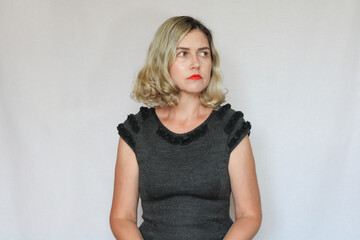 Fototapeta premium Beautiful middle-aged blond woman on a white background