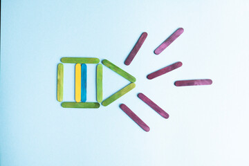 War in Ukraine. Ukrainian flag from wooden sticks in the center of the house on a blue background, vertical frame, top view. Rockets fly into the house. Attack. Attack on the country. political confli