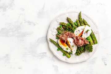 Ketogenic diet meal Poached egg with asparagus spears and prosciutto toast. banner, menu recipe place for text, top view