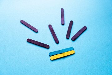 war in Ukraine. Broken Ukrainian flag on a blue background. Rockets fly to Ukraine. Painting from colored sticks