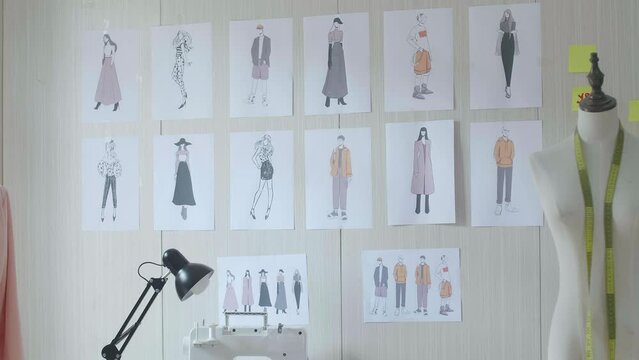 Clothes Drawing Pictures Being Sticked On The Wall In The Designer Studio
