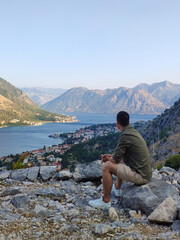 Man is looking at Kotor bay from above in Kotor, Montenegro