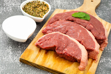 raw picanha steaks and seasoning, high angle