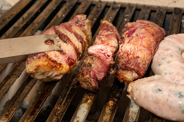 picanha steaks and sausage on hot grill