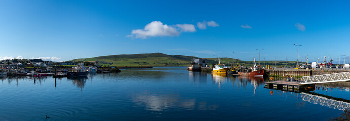 panorama landscape view of the fishing port and docks at Dingle Harbor in County Kerry