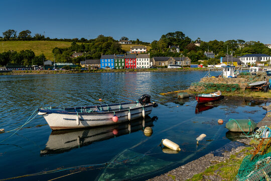 small wooden rowboats and fishing nets and crab traps in Bantry Bay withe downtown Bantry in the background