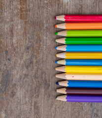blunt coloured pencils on wood floor.
