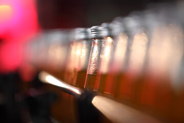 Conveyor belt, industrial production line, juice in bottles on beverage plant , selective focus.