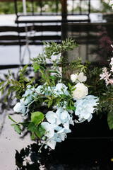 A composition of artificial flowers at the celebration. wedding decor in blue and pink tones in nature. 