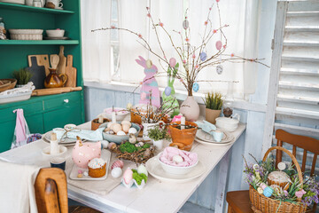 Table decoration for Easter celebration in kitchen.Tablescape for Easter holiday at home.Family...