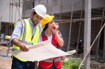 Mechanical Engineer team Working with paper work on construction home building site	