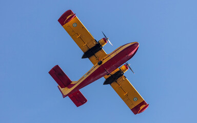 Canadair flight, Amphibious Firefighting Aircraft, Scooper on clear blue sky background. Under view