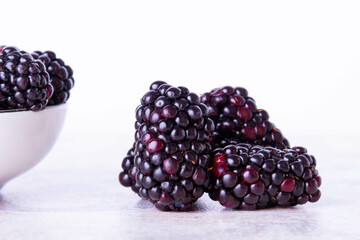 Blackberry berries. Black berries close-up on a wooden surface. Copyspace.