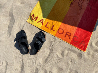 Playa de Palma beach Mallorca towel on the beach and sandals. © dragancfm