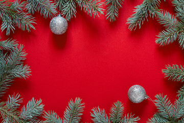 Fototapeta na wymiar Christmas red background from green fir branches, frame, top view