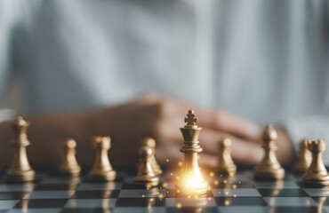 Professional businesswoman think planning challenging strategy to lead success and management leadership competition to victory. Woman playing chess game on desk. Business corporate growth target