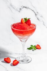 Frose cocktail mixed with strawberriess with pink wine. Alcoholic Beverage. Boozy Frozen Rose Frose