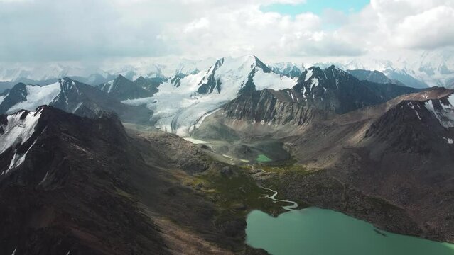 Ala-Kul Lake in Issyk Kul Region in Kyrgyzstan. Drone footage 4K. Mountains with big lake and epic clouds. 
