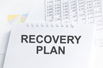 Fototapeta premium Recovery Plan inscription on a notebook on an office desk, a business concept