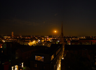 Fototapeta premium Aerial view of the spire of St. Georges church Southport at night with moon rise, Southport, Merseyside