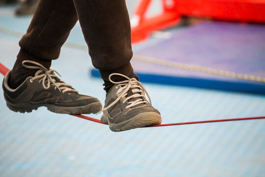 The feet of the tightrope Walker on blurred background