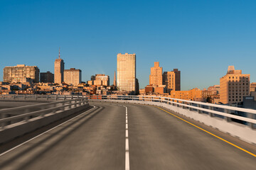 Obraz premium Empty urban asphalt road exterior with city buildings background. New modern highway concrete construction. Concept way to success. Transportation logistic industry fast delivery. San Francisco. USA.