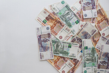 Various Russian banknotes on a light background with space for text.