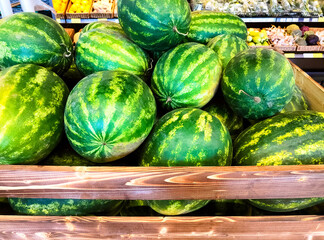  Fresh ripe green watermelons in the supermarket. Summer fruits in grocery store.
