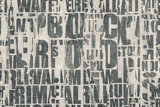 Collage of torn street posters. Abstract black and white lettering background.