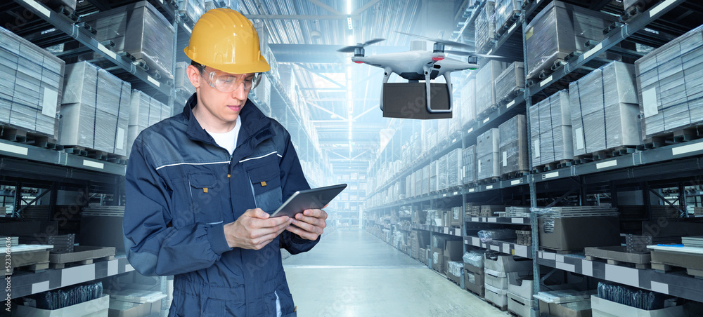 Poster Warehouse manager with digital tablet controls drone with a package. Unmanned delivery concept	