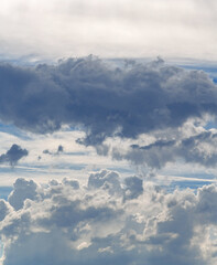 Sky with clouds. White cumulus clouds against a cloudy dramatic sky.