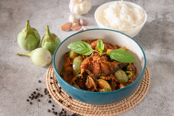 Stir fry spicy catfish with red curry paste, served with streamed jasmine rice as traditional food Thailand