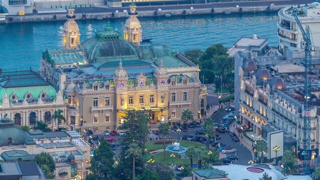 Cityscape of Monte Carlo, Monaco day to night transition timelapse with roofs of buildings and casino square after summer sunset. Aerial top view from hills.