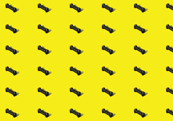 3d vector illustration of a black bone patella with shades of shadows in the background lined up at intervals on a yellow background.