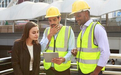 A team of skilled executive engineers is discussing the details of the construction plan