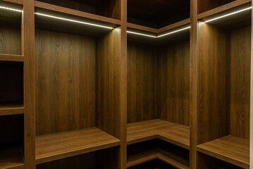 Big wardrobe room in modern apartment or hotel. large wooden locker room