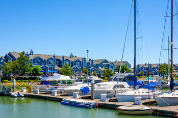 Fototapeta na wymiar Pleasure boats moored against a pontoon in Benicia Marina in California, USA