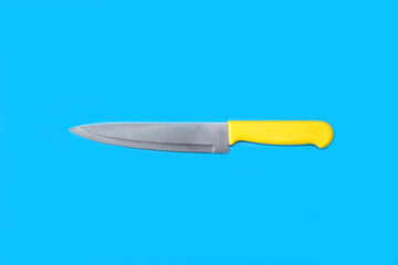 Kitchen knife on a bright blue background. Minimal art