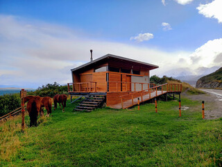 Modular wooden house in a natural environment and extreme landscape of Tierra del Fuego. Panoramic...