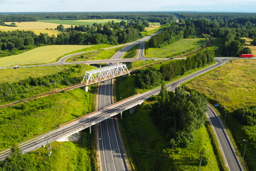 Aerial view of an automobile road junction intersection with bridges and trucks and cars on a sunny...