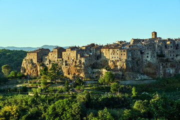 Medieval stone buildings on a rocky cliff in the town of Pitigliano in Tuscany, Italy
