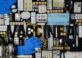 Various medical equipment, thermometer, ampoules, pipette, drugs, tablets, capsules, spray, patch, syringe, vials on a black background. Medicine, pharmacy, hospital, treatment, vaccine concept.