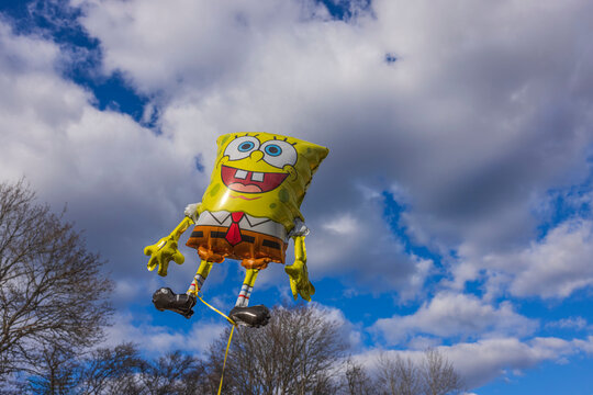 Beautiful view of holiday foldable sponge Bob figure on blue sky and white clouds background. Sweden. 