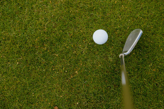 Golf Club And Golf Ball On Green Grass, Top View